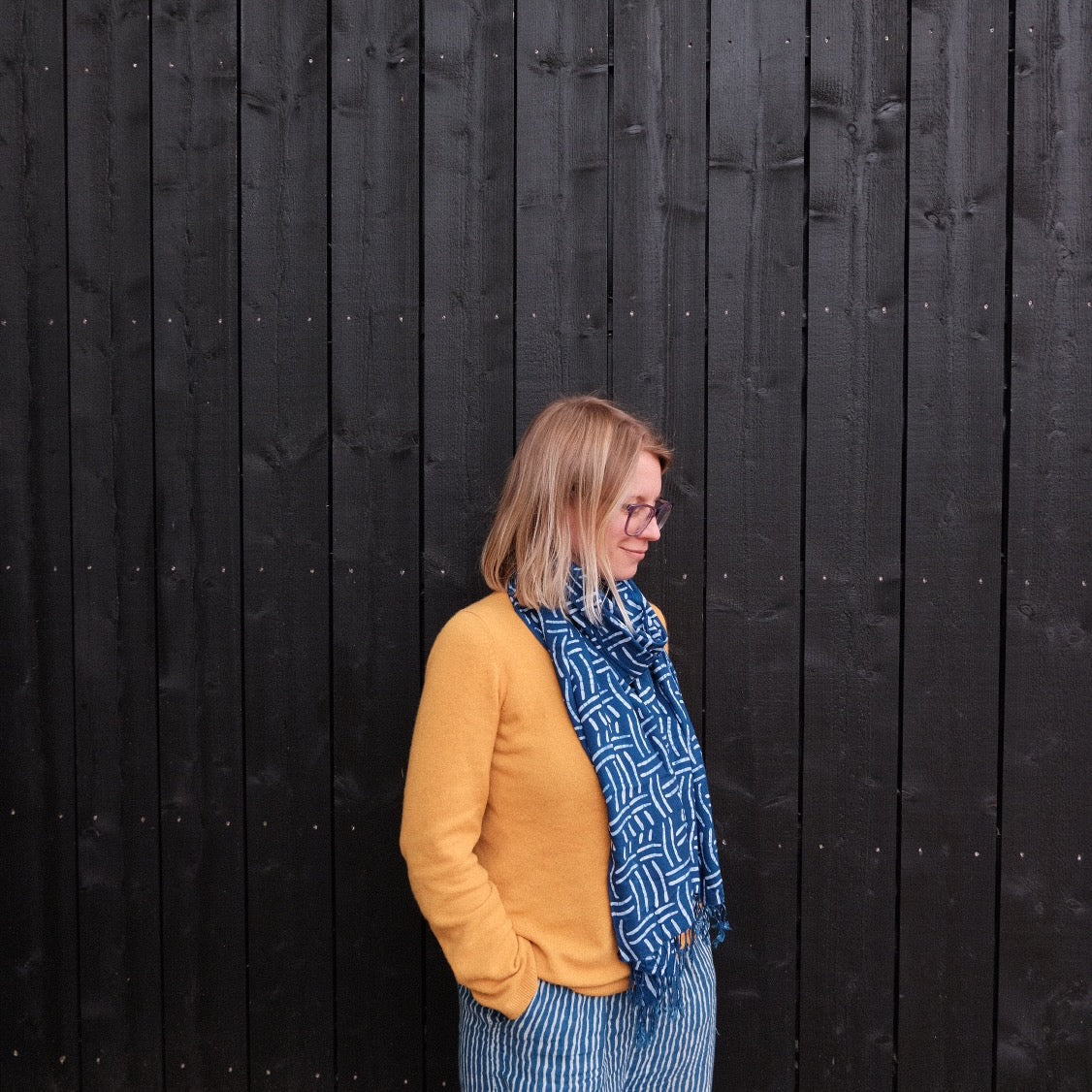 Woman wearing a blue indigo batik scarf