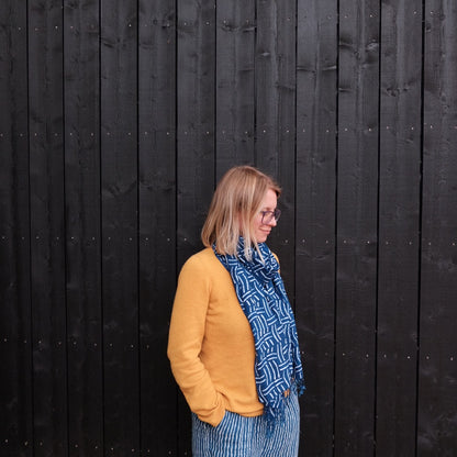 Woman wearing a blue indigo batik scarf
