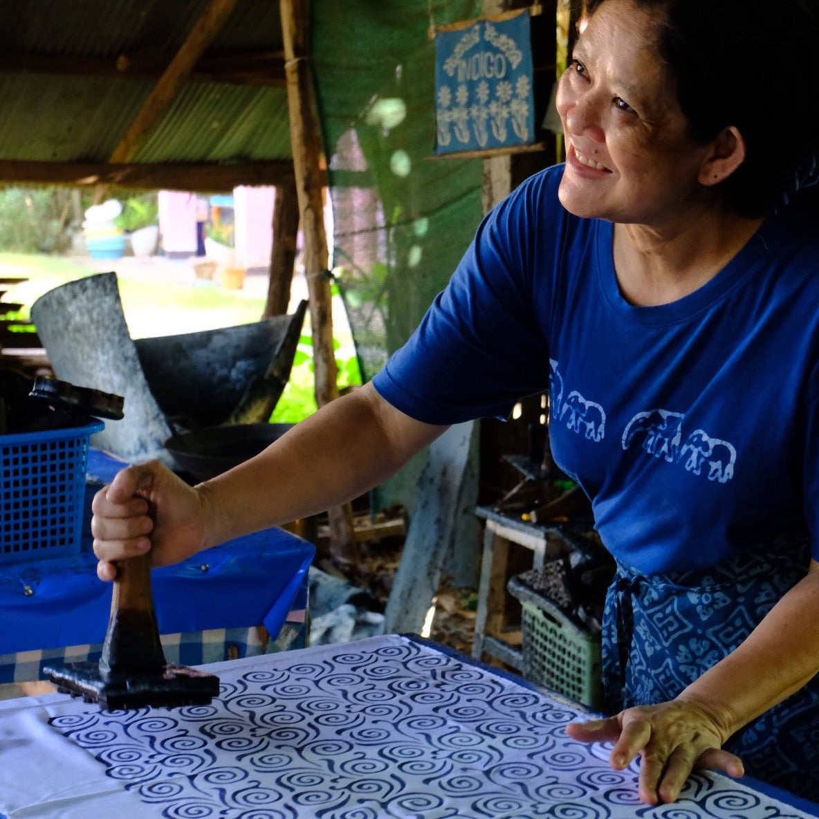 Pannee at Mohom Ban Paluang Batik in Phrae. Pannee is stamping batik wax onto a cotton scarf.