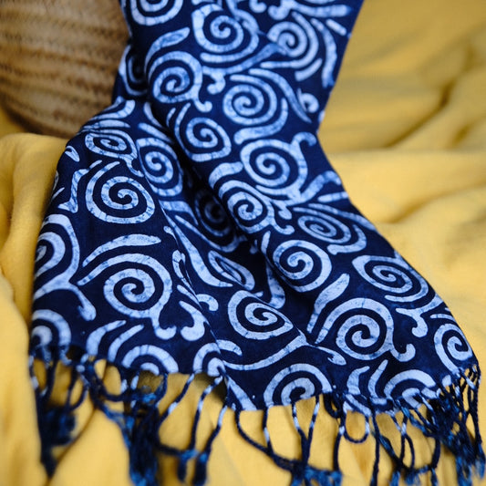 Blue patterned scarf with a handprinted batik spiral pattern.