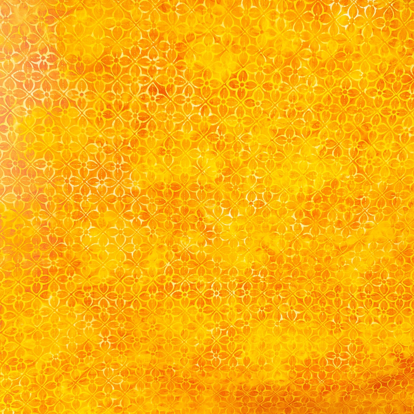 Orange and yellow batik fabric with geometric flower print