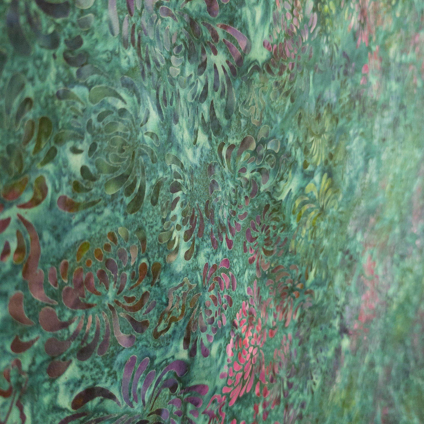 Hand printed batik fabric from Java with a multicoloured floral pattern