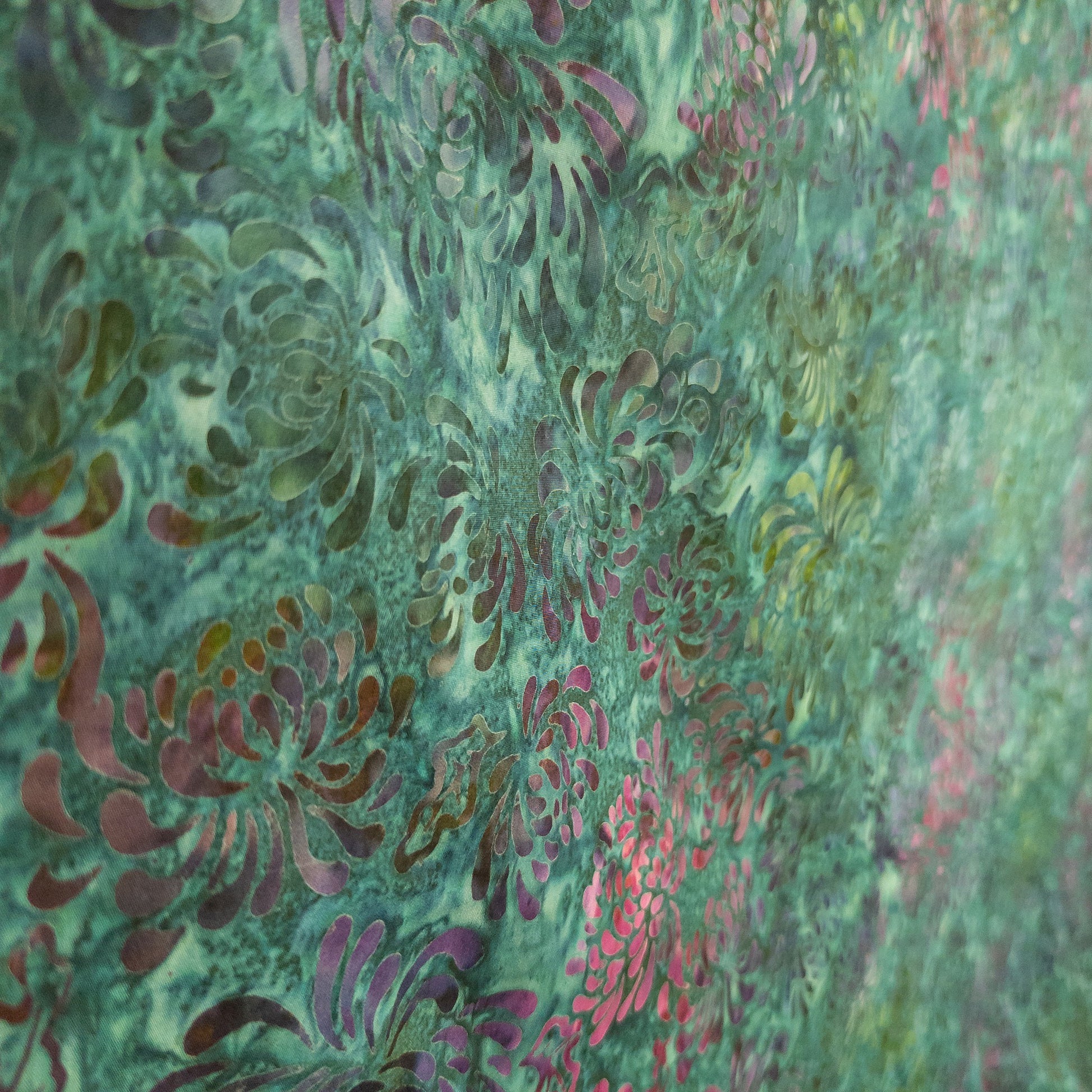 Hand printed batik fabric from Java with a multicoloured floral pattern