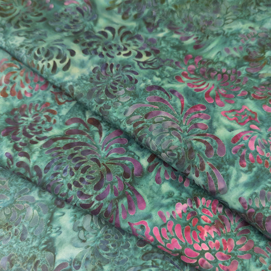 Floral batik fabric with a mottled teal background