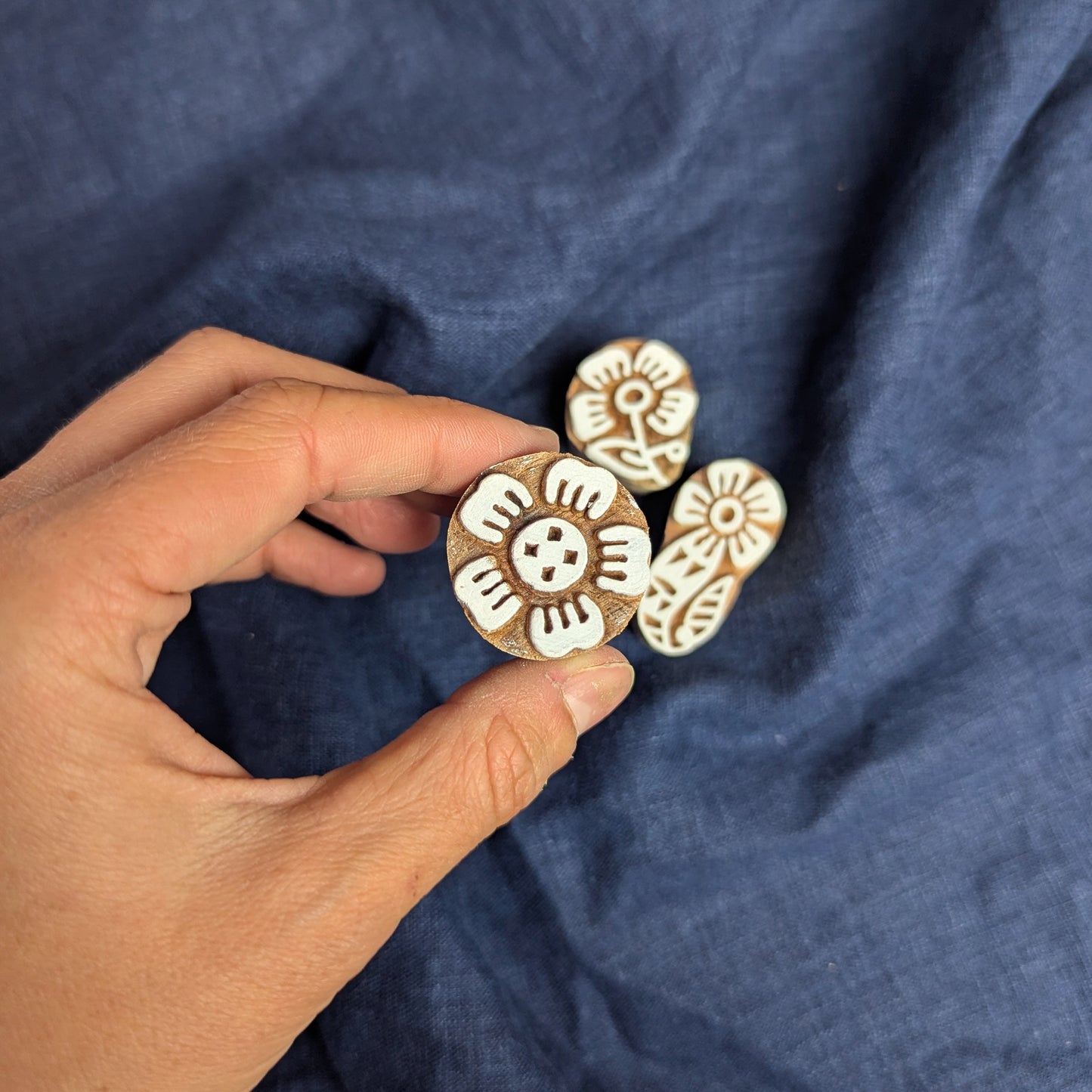 Five petal flower stamp being displayed as part of a set of floral woodblocks