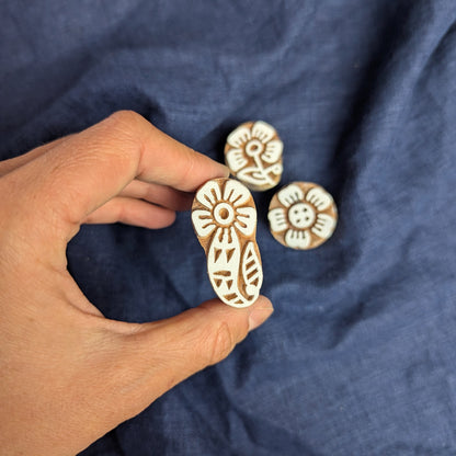 Paisley flower printing block, being displayed as part of a set of floral woodblocks