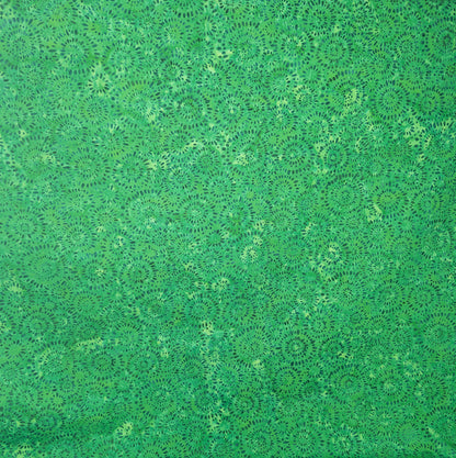 Green batik fabric from Indonesia with circle firework-inspired pattern