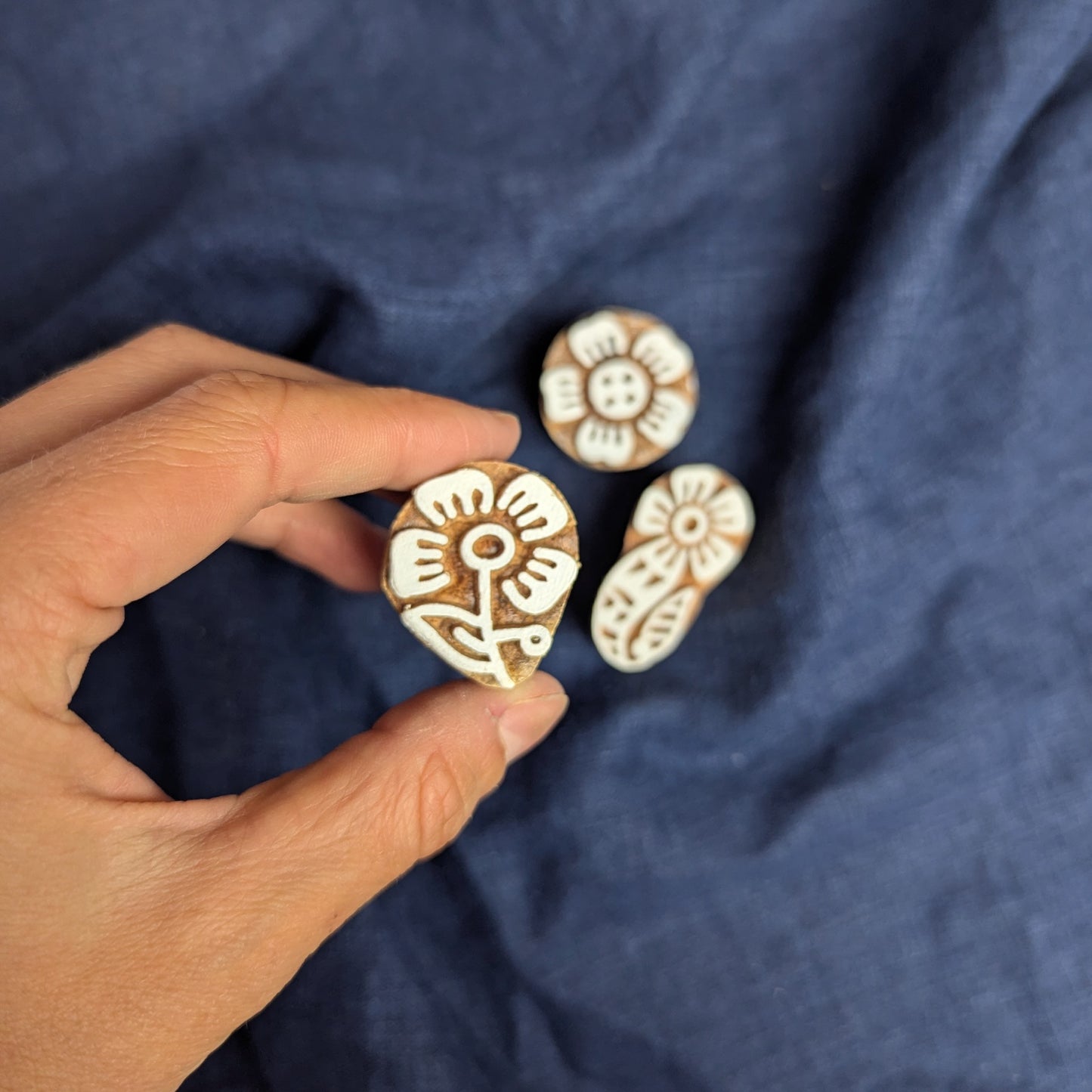 Four petalled flower stamp, shown as part of a set of floral wood blocks