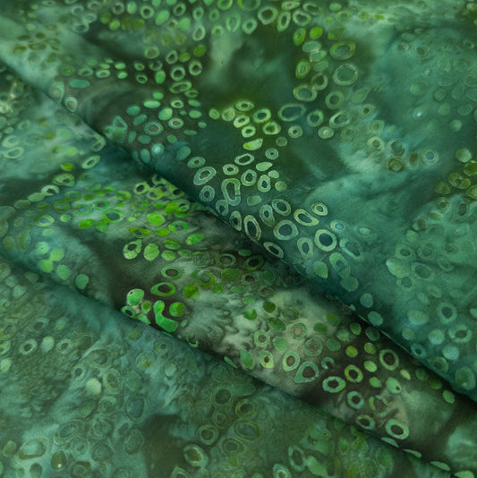Green batik fabric with circular bubble pattern
