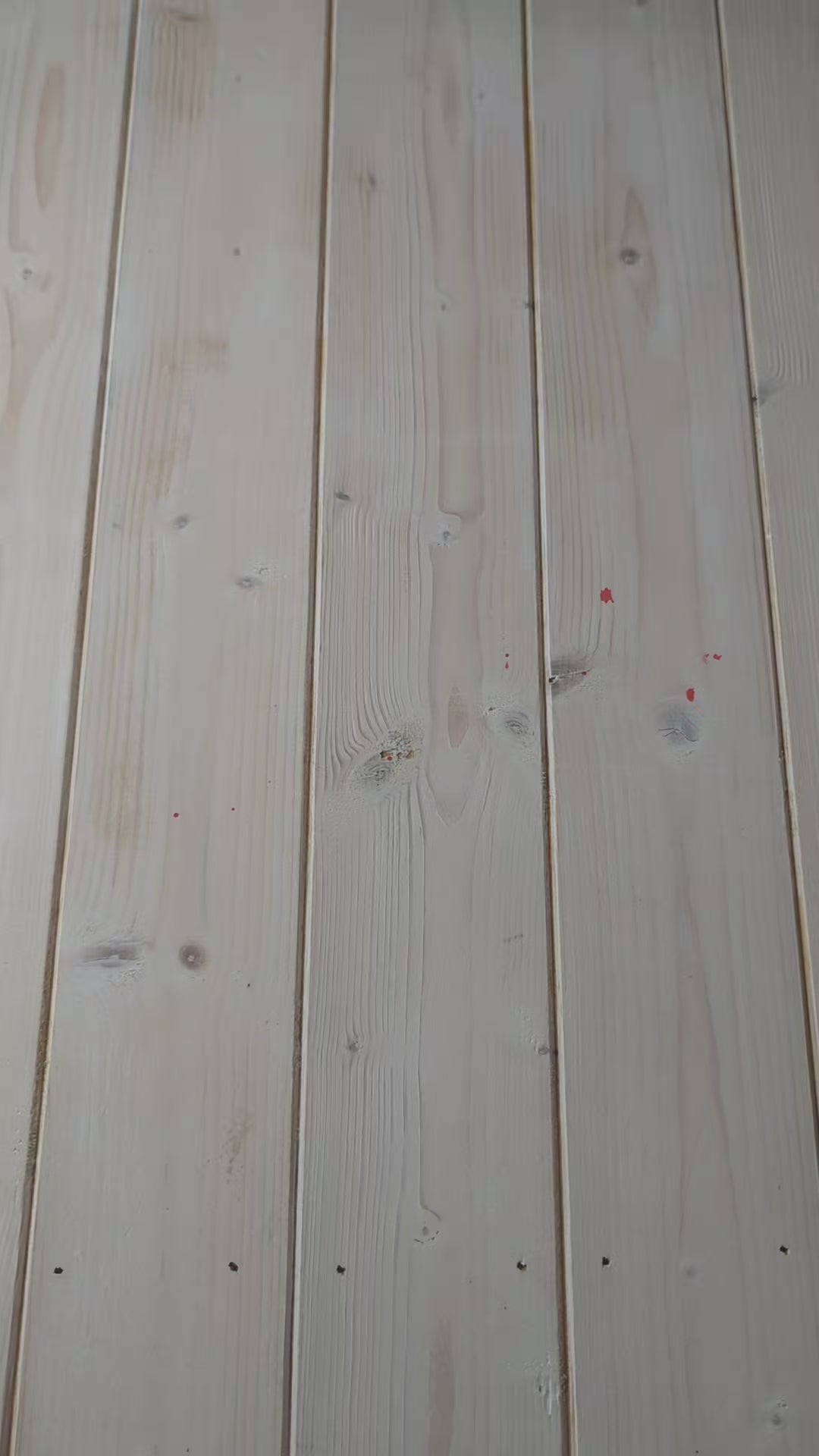 A video showing a bolt of blue ikat fabric, followed by a close up of a hand scrunching the fabric, and then a woman holding the fabric to display its full ikat pattern in red and white.