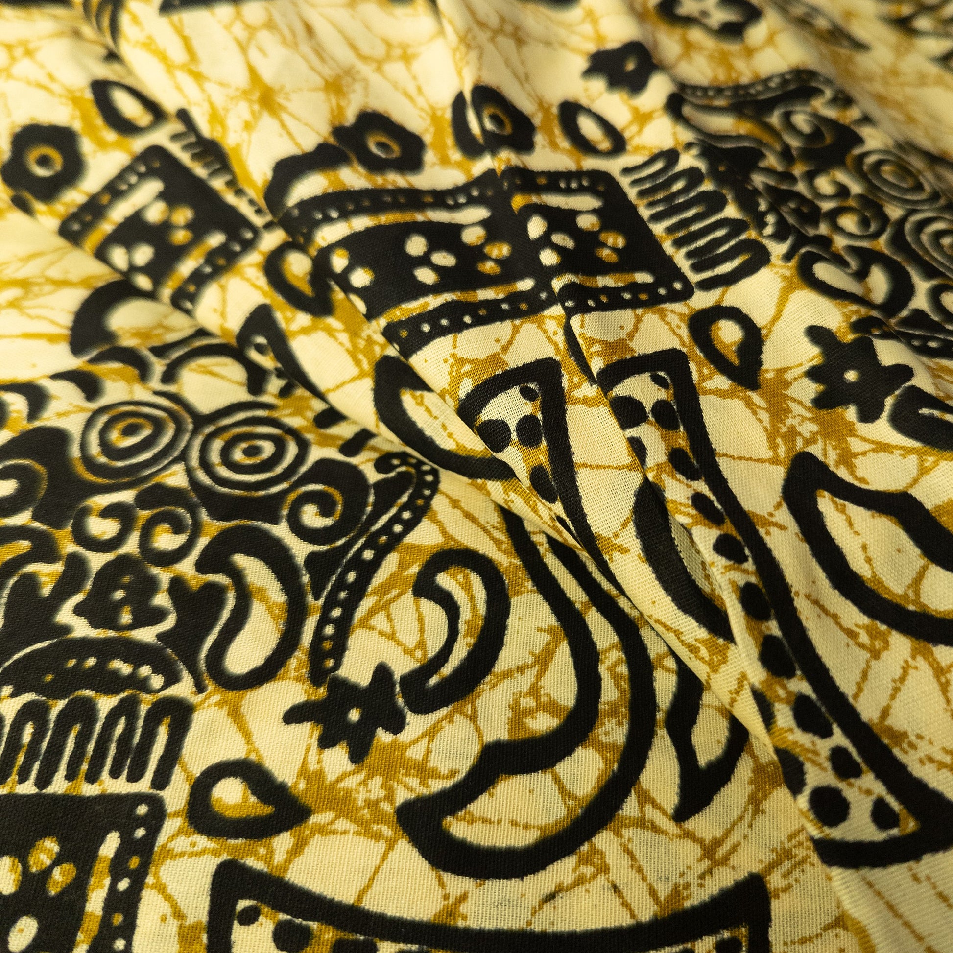 Balinese batik sarong in pale yellow cotton with a black overprinted crackle batik design